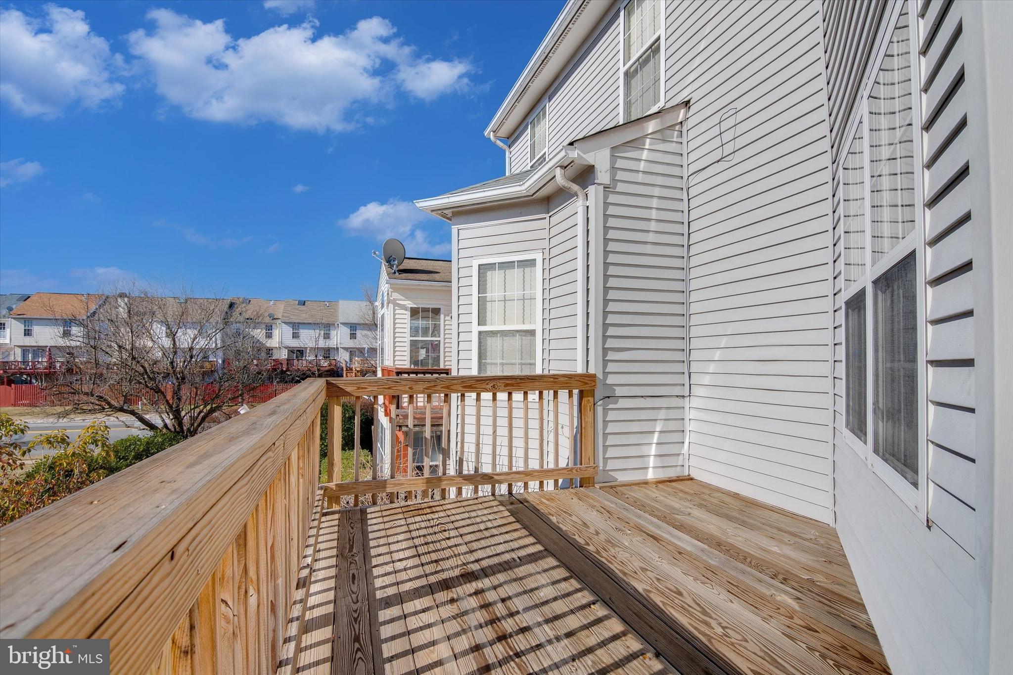 45457 Bluemont Junction Square Sterling, VA 20164 - Photo 21 of 26 a view of balcony with wooden floor and fence