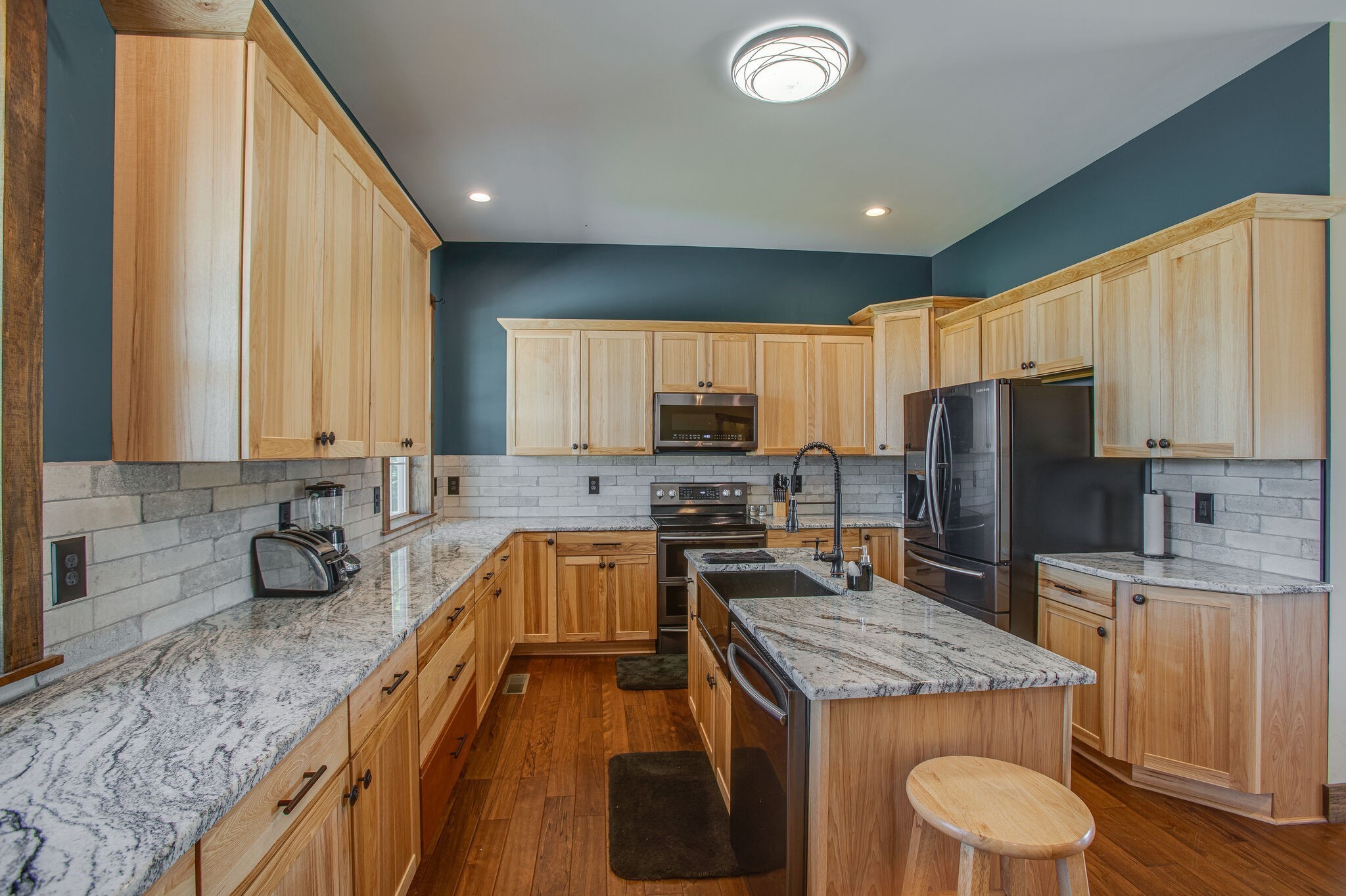 103 Heath Branch Road Chapel Hill, TN 37034 - Photo 13 of 49 a kitchen with a stove a sink a microwave a refrigerator and cabinets