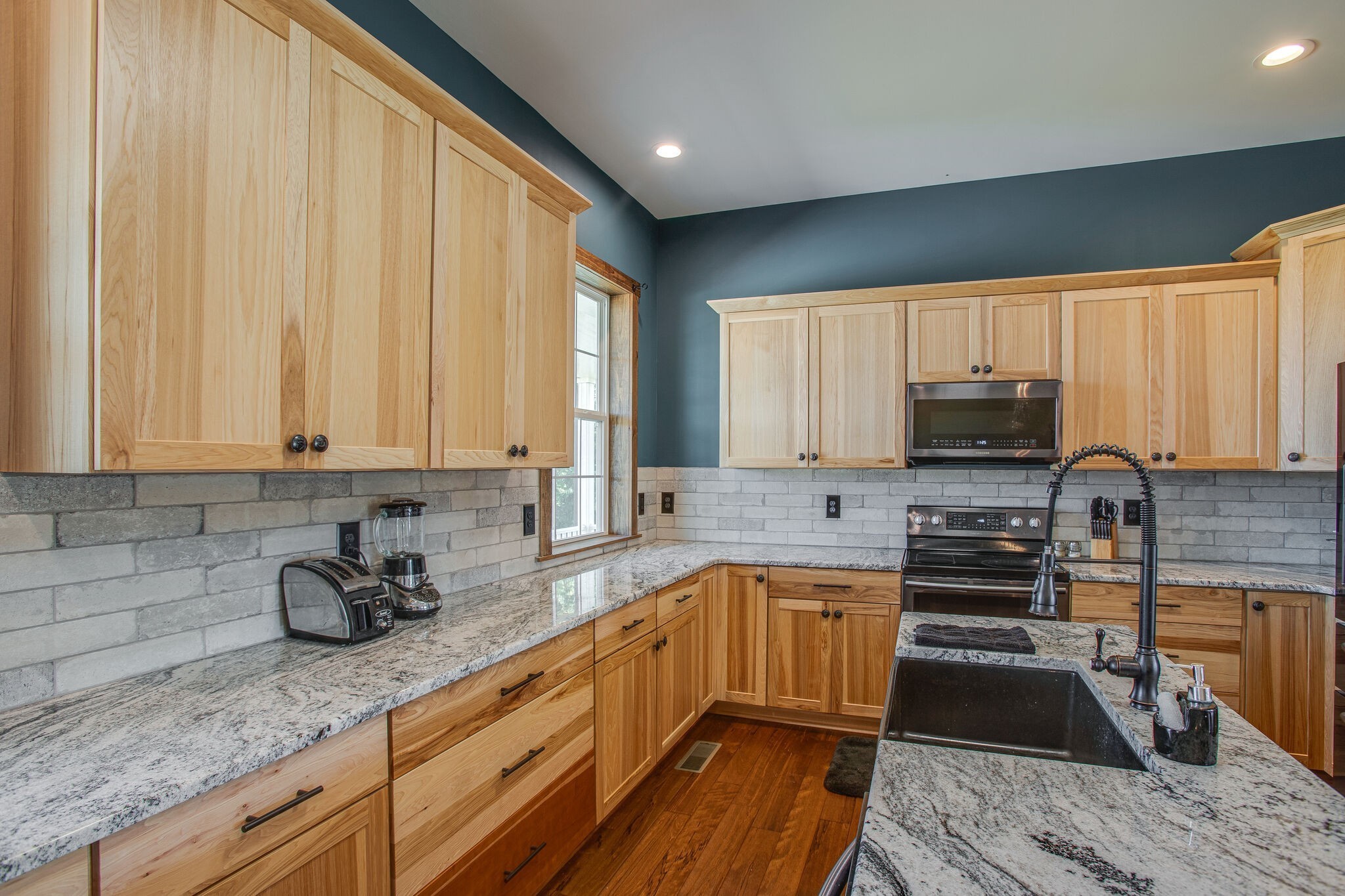 103 Heath Branch Road Chapel Hill, TN 37034 - Photo 14 of 49 a kitchen with kitchen island granite countertop a sink a counter space appliances and cabinets