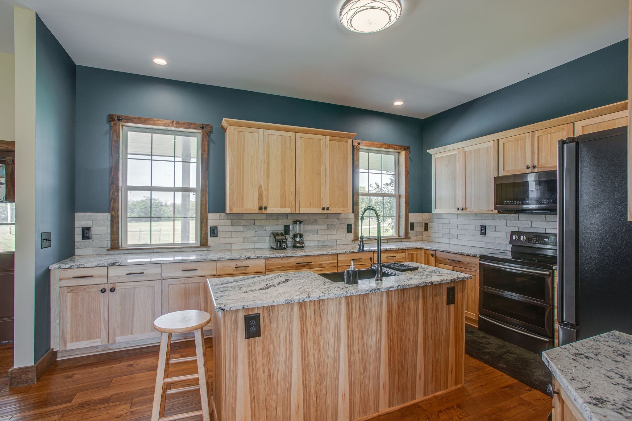 103 Heath Branch Road Chapel Hill, TN 37034 - Photo 16 of 49 a kitchen with granite countertop a sink stove refrigerator and cabinets