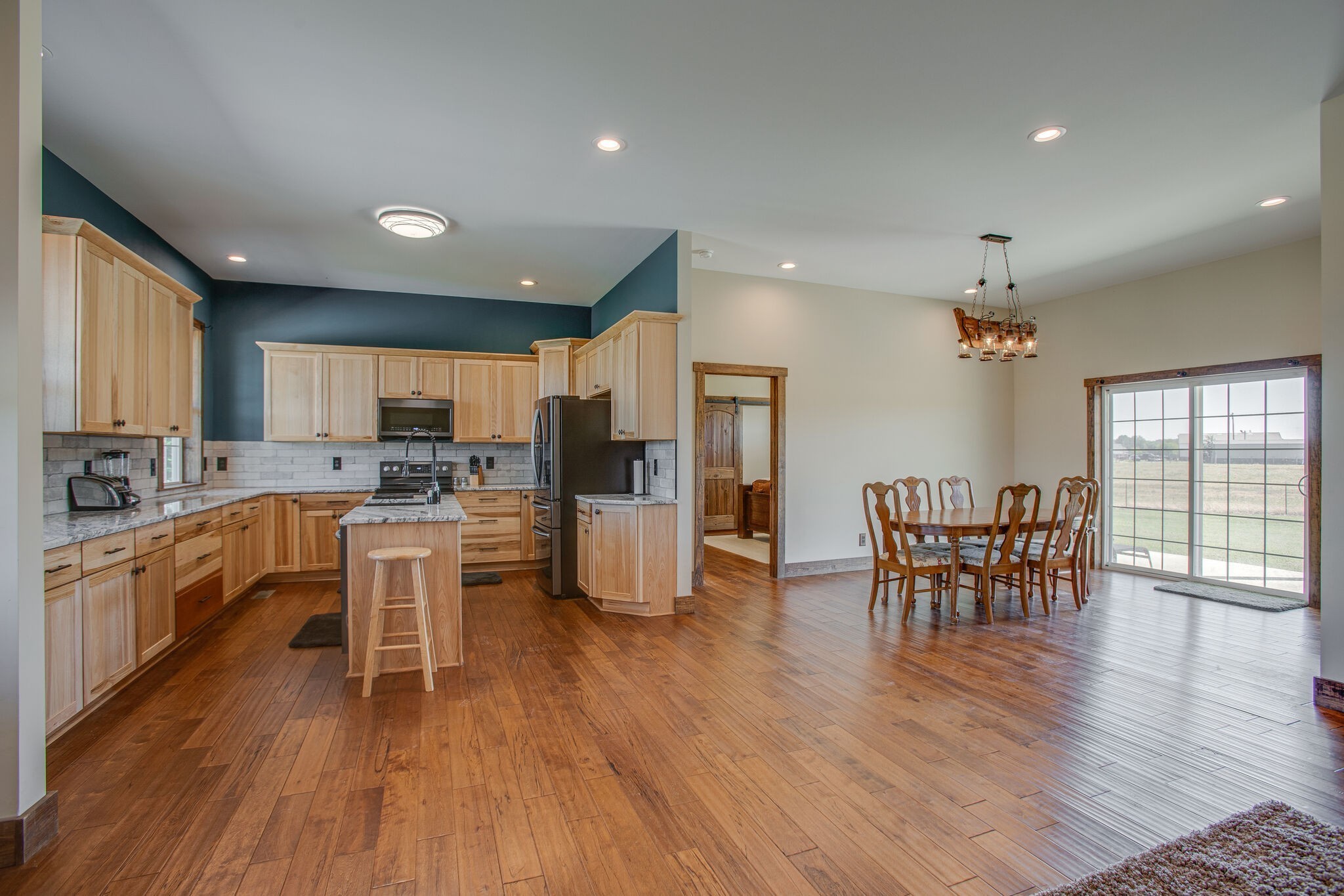 103 Heath Branch Road Chapel Hill, TN 37034 - Photo 10 of 49 a kitchen with stainless steel appliances granite countertop wooden floor a dining table and chairs