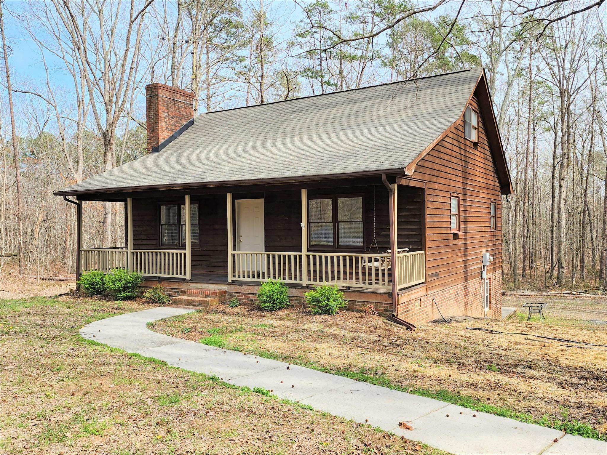 5542 Wagoner Road Gold Hill, NC 28071 - Photo 1 of 34 a front view of a house with a garden and plants