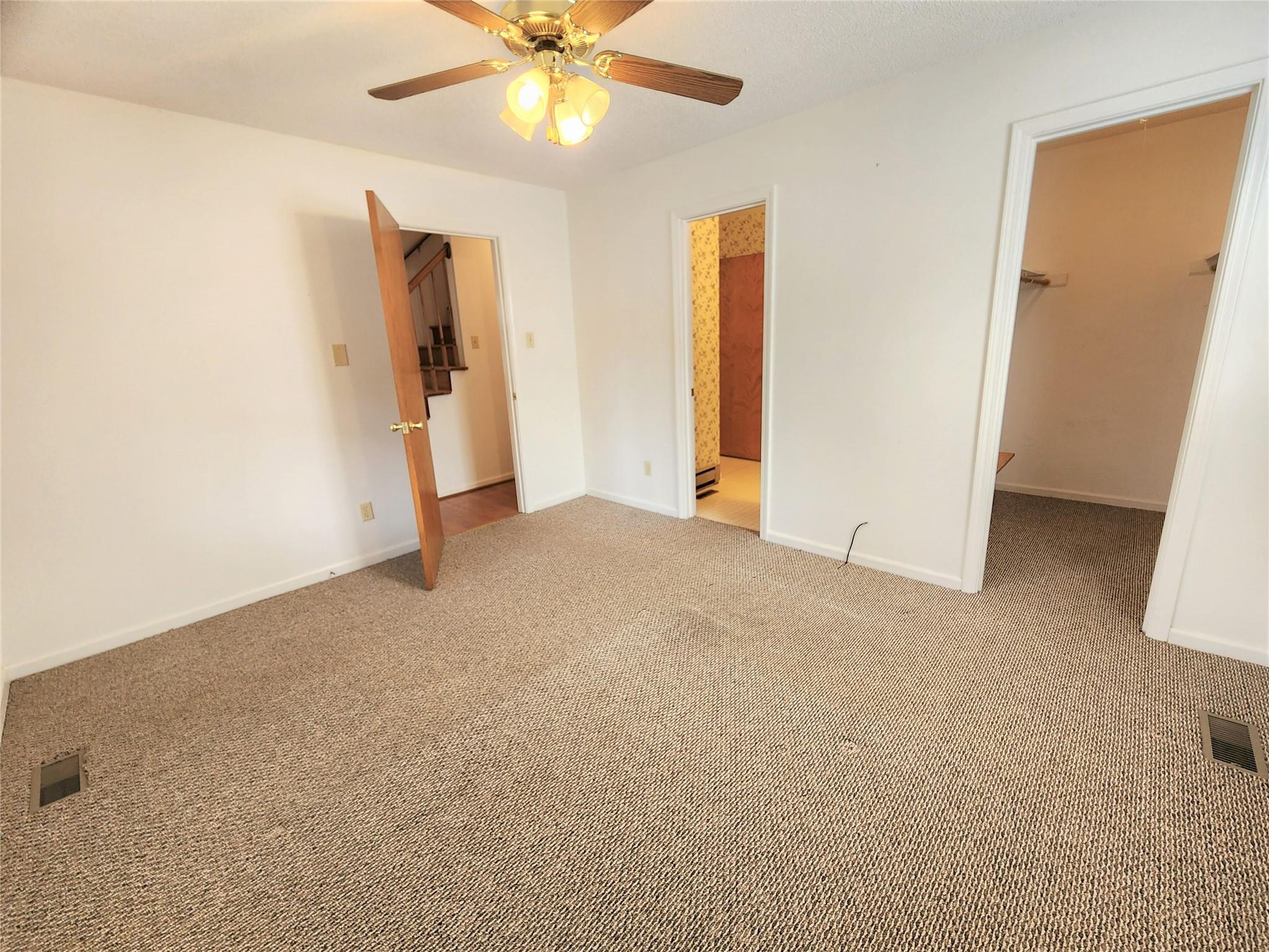 5542 Wagoner Road Gold Hill, NC 28071 - Photo 13 of 34 a view of a big room with closet and a ceiling fan