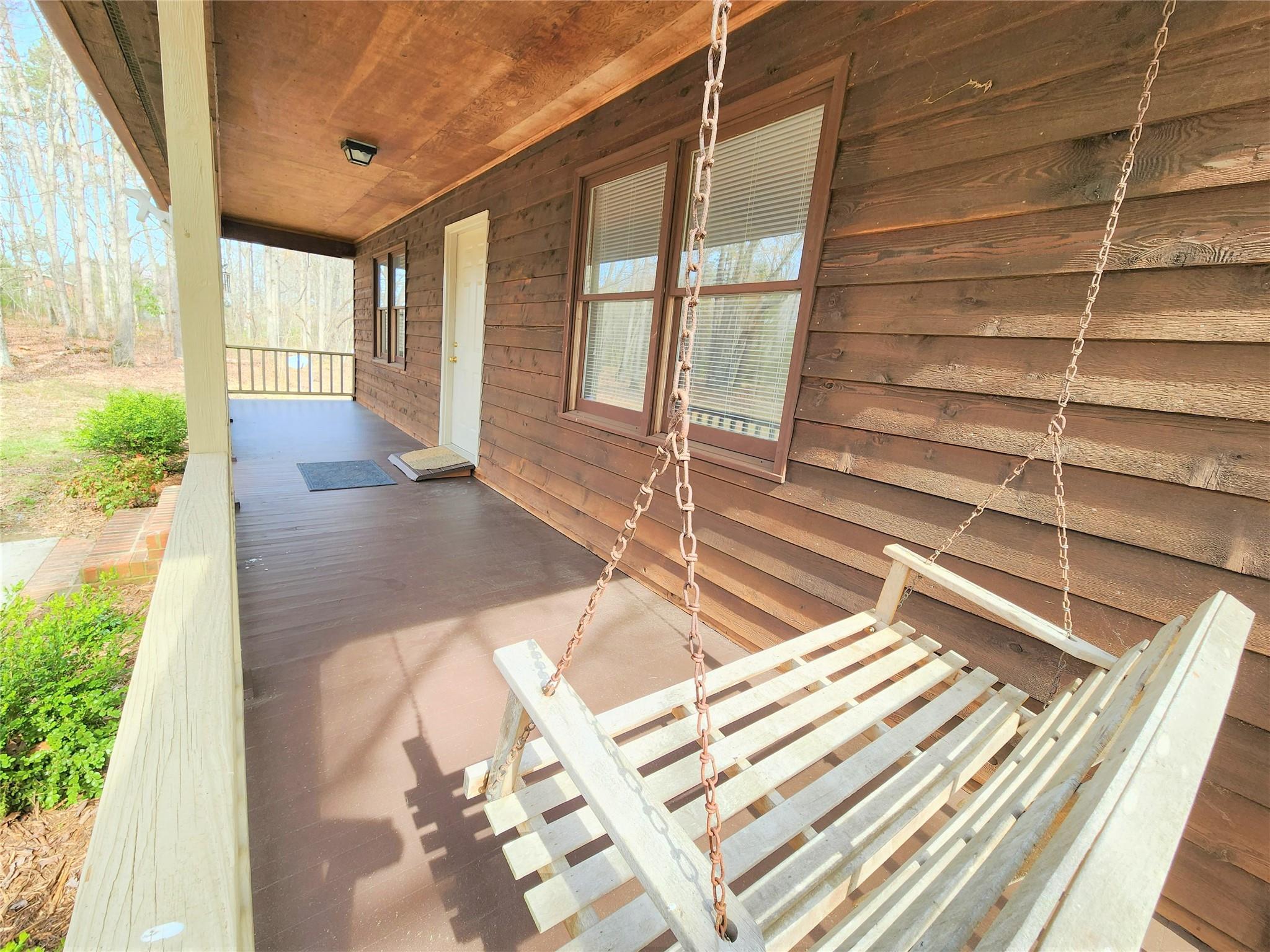 5542 Wagoner Road Gold Hill, NC 28071 - Photo 3 of 34 a view of a living room with a balcony and floor to ceiling windows with wooden floor