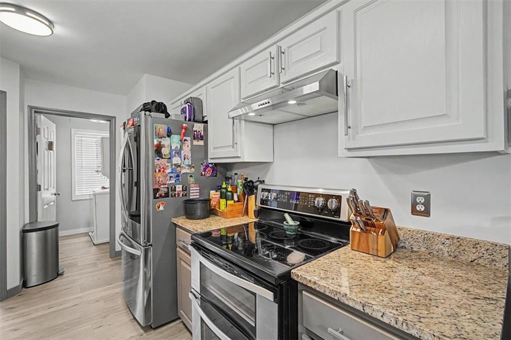 409 Windsor Way Canton, GA 30115 - Photo 10 of 51 a kitchen with stainless steel appliances granite countertop a sink stove and refrigerator