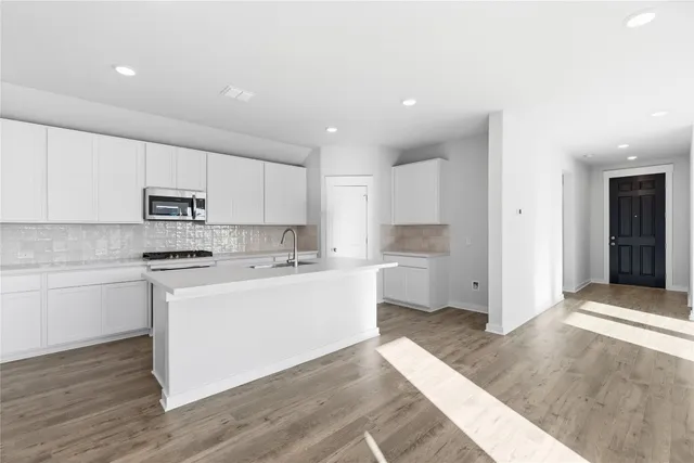 a kitchen with white cabinets and white appliances