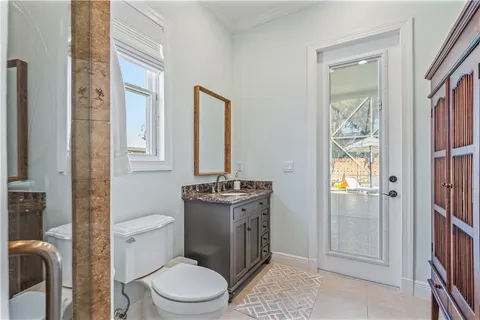 a bathroom with a toilet a sink and a mirror