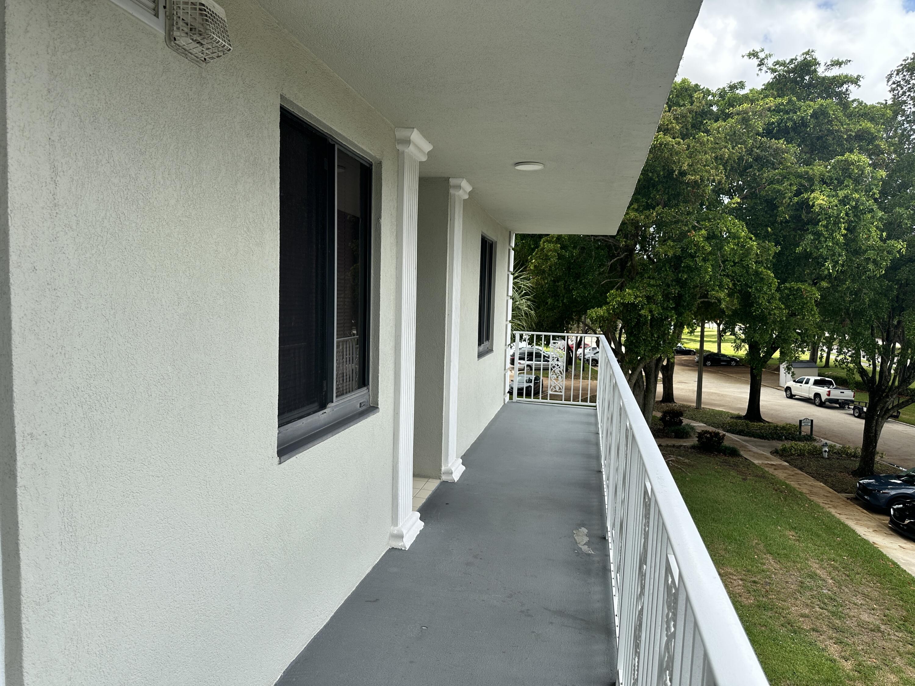2761 Village Boulevard, Unit 306 West Palm Beach, FL 33409 - Photo 2 of 15 a view of a backyard with swimming pool