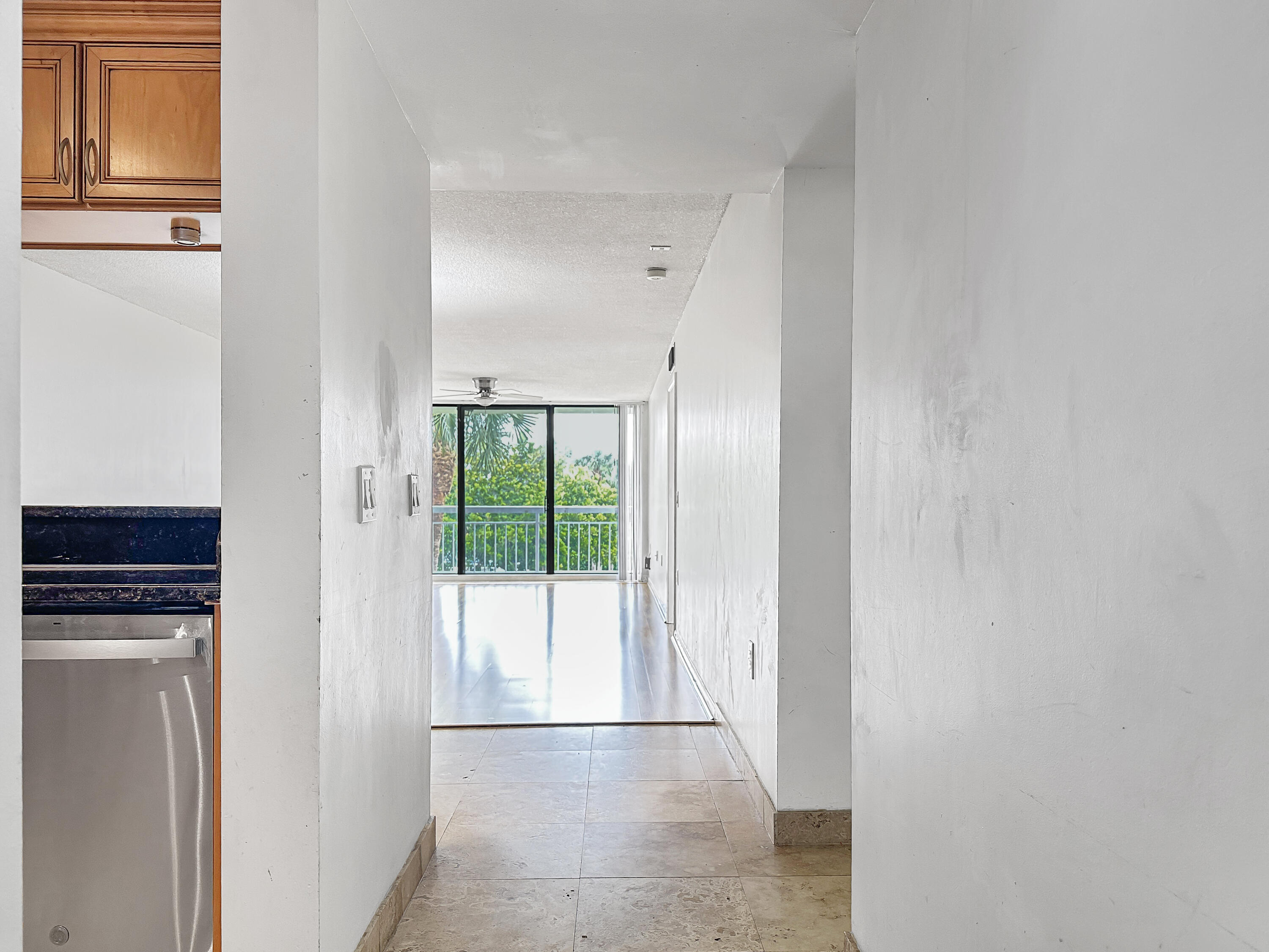 2761 Village Boulevard, Unit 306 West Palm Beach, FL 33409 - Photo 3 of 15 a view of a kitchen from the hallway