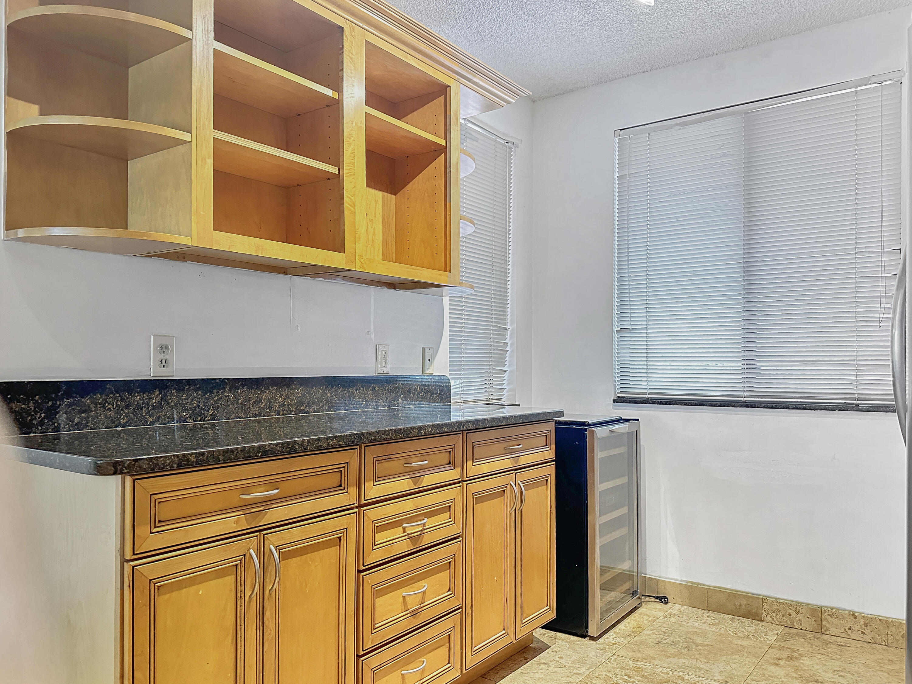 2761 Village Boulevard, Unit 306 West Palm Beach, FL 33409 - Photo 5 of 15 a kitchen with a sink and cabinets