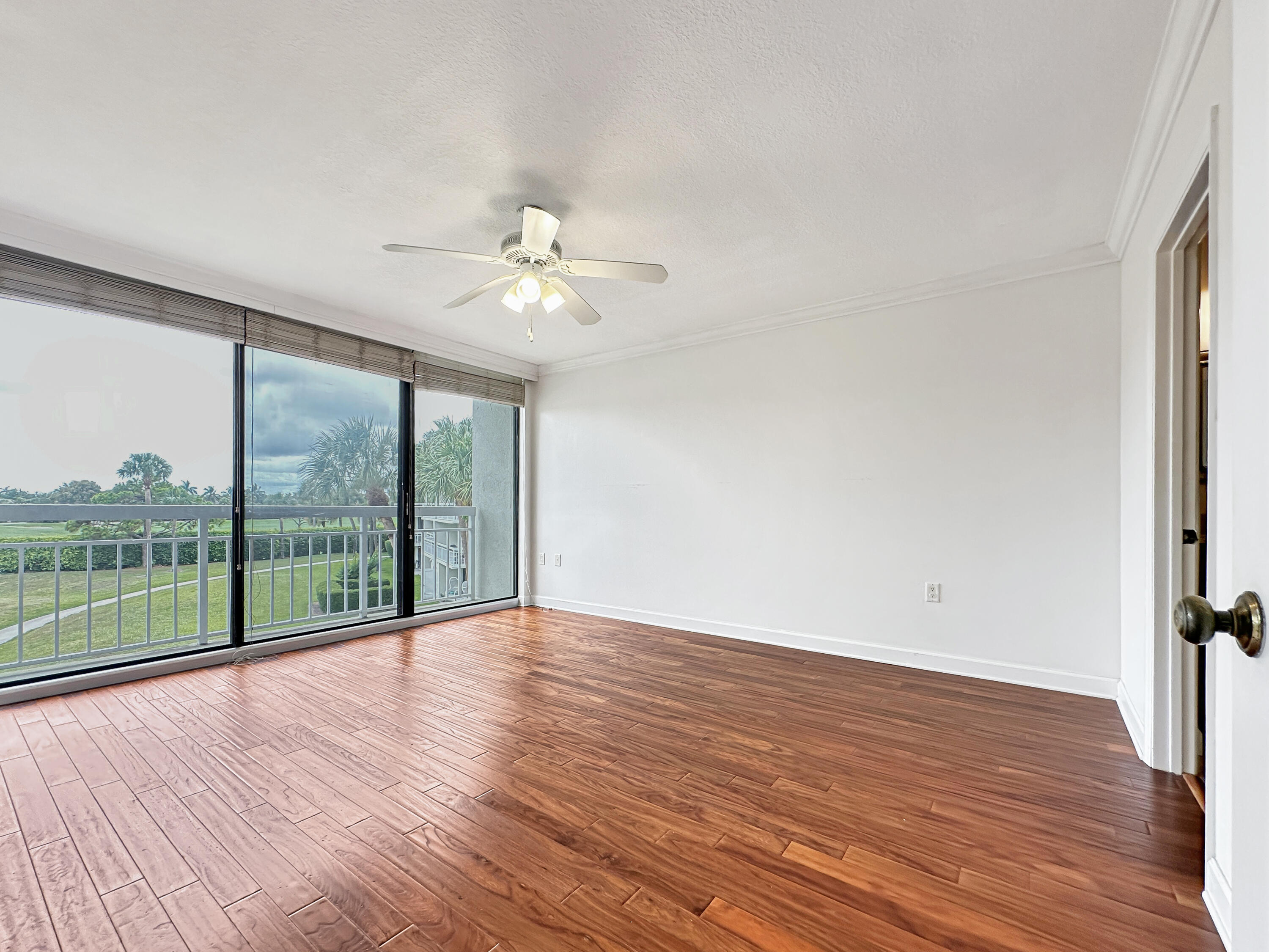 2761 Village Boulevard, Unit 306 West Palm Beach, FL 33409 - Photo 8 of 15 wooden floor in an empty room with a window