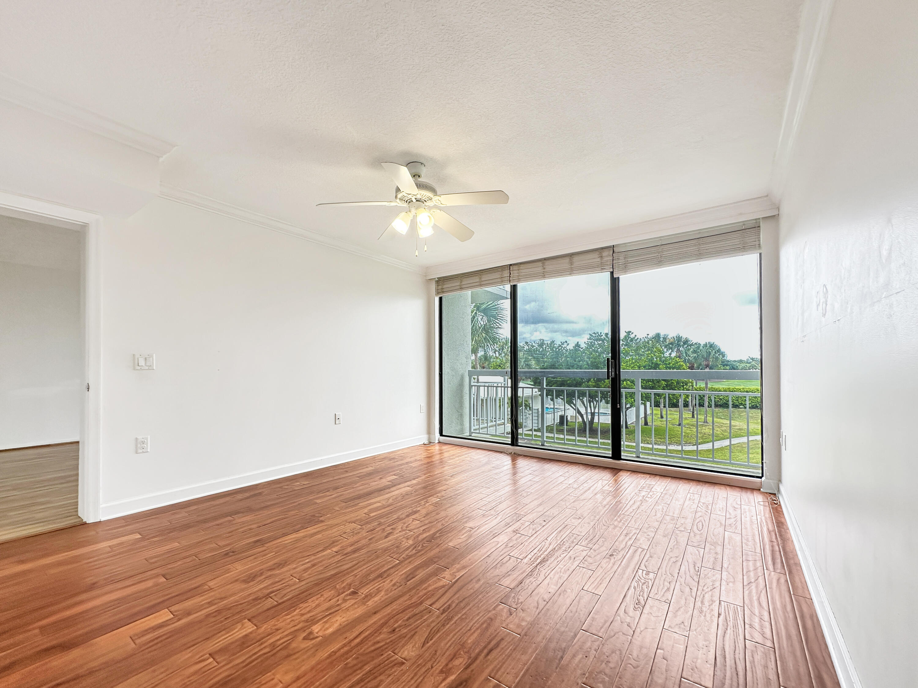 2761 Village Boulevard, Unit 306 West Palm Beach, FL 33409 - Photo 9 of 15 wooden floor in an empty room with a window