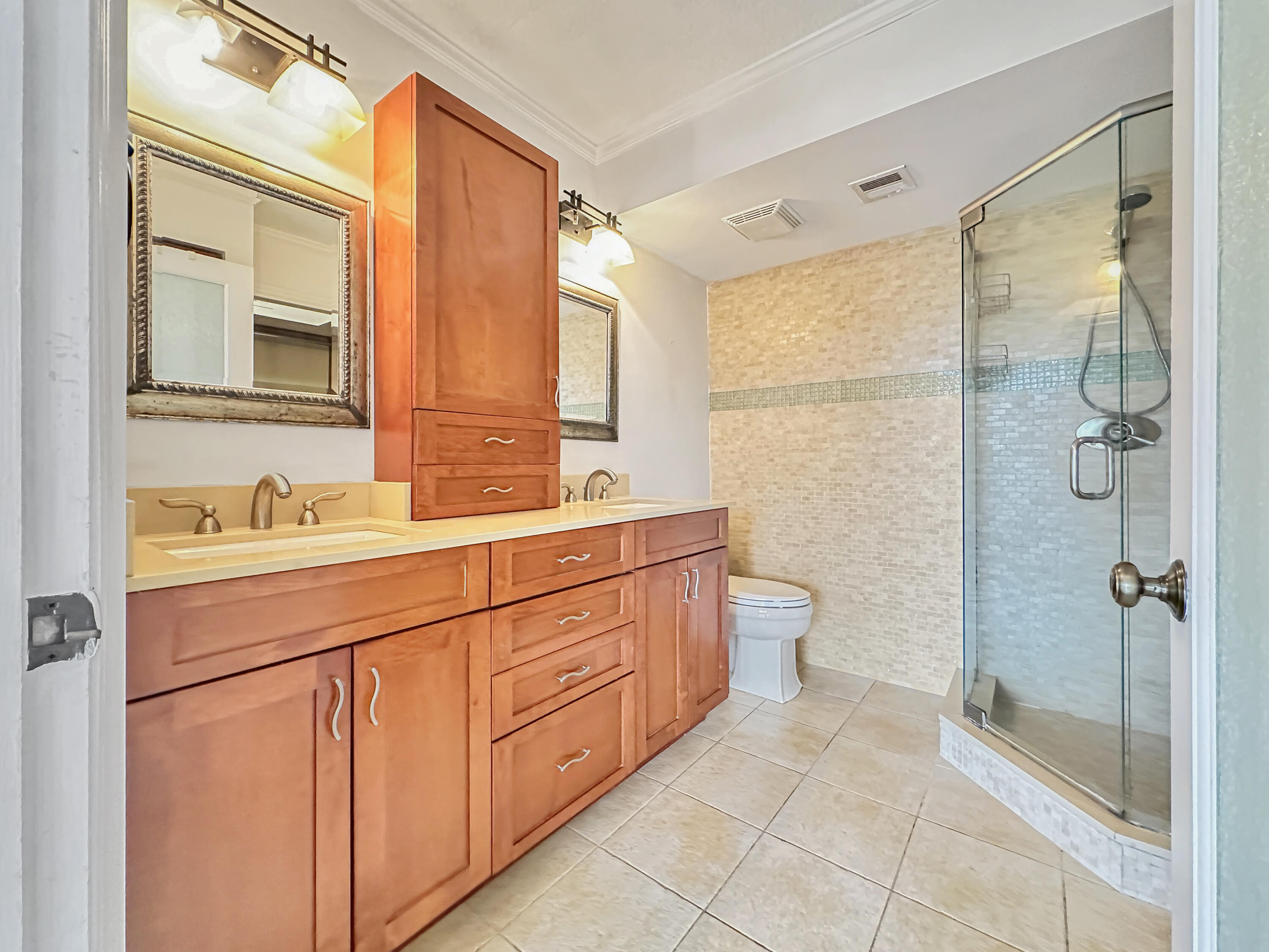 2761 Village Boulevard, Unit 306 West Palm Beach, FL 33409 - Photo 10 of 15 a bathroom with a double vanity sink toilet mirror and shower
