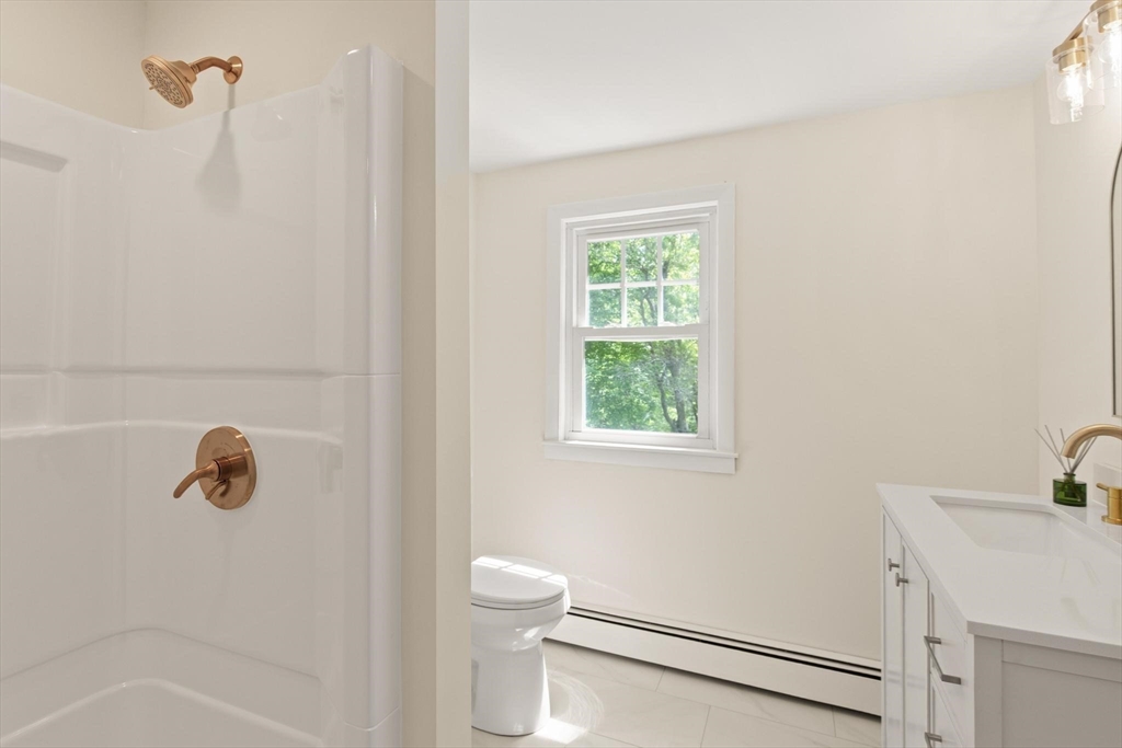 1049 Pleasant Street Canton, MA 02021 - Photo 14 of 16 a bathroom with a sink a toilet and shower