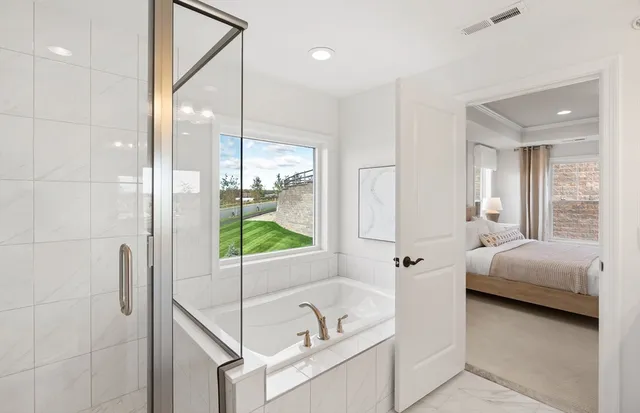 a bedroom with bed and a large window