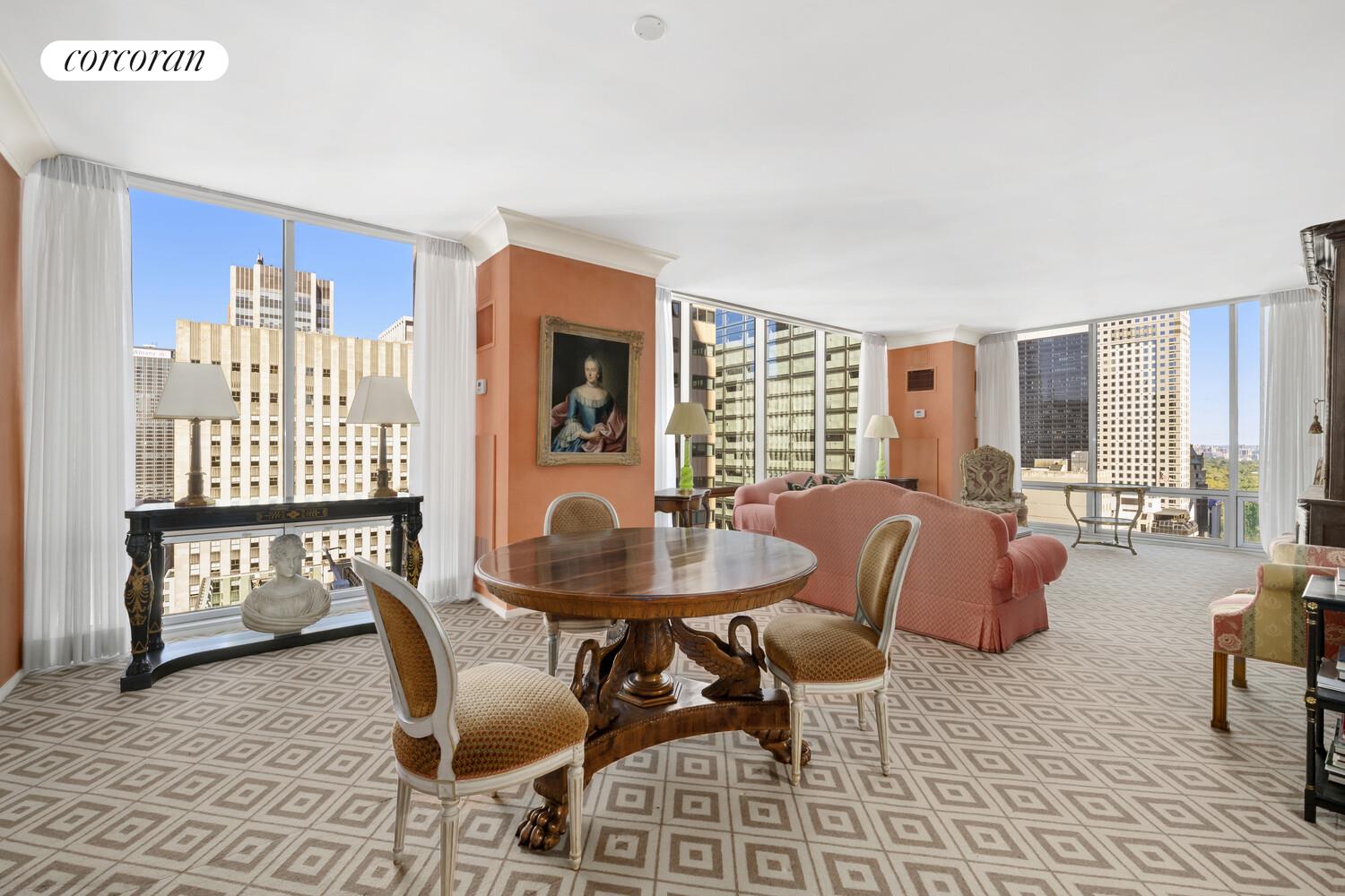 641 5th Avenue, Unit 28A Manhattan, NY 10022 - Photo 10 of 16 a living room with furniture and a floor to ceiling window