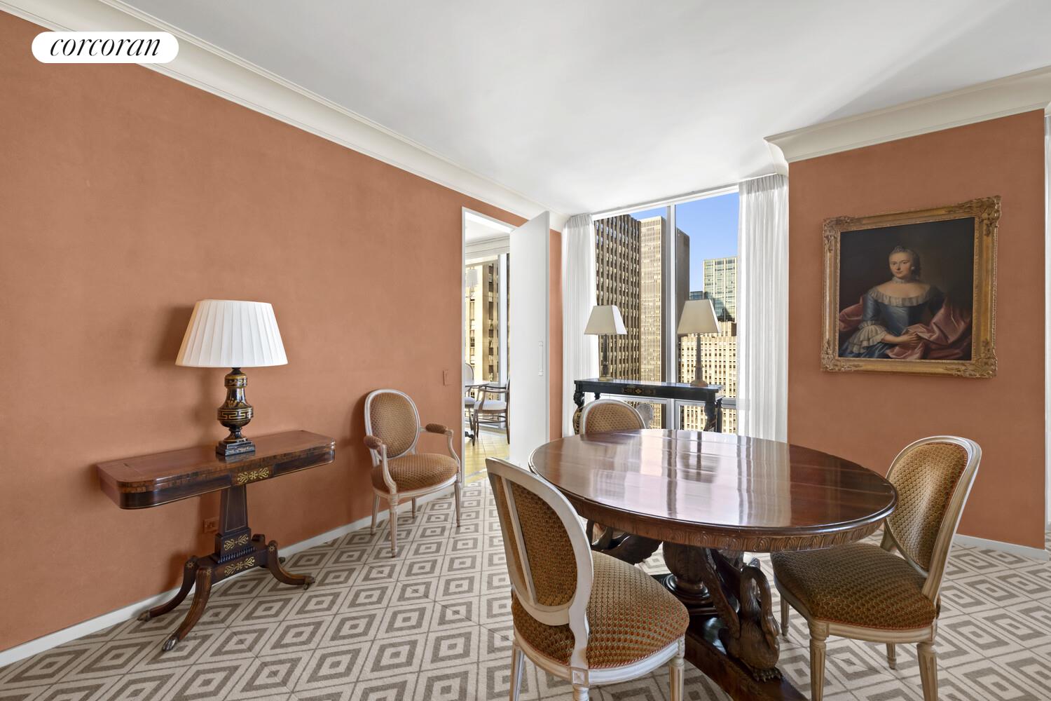 641 5th Avenue, Unit 28A Manhattan, NY 10022 - Photo 12 of 16 a dining room with furniture and wooden floor