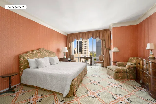 a bedroom with furniture and a large mirror