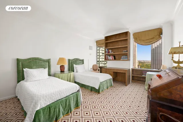 a bedroom with two beds and a window