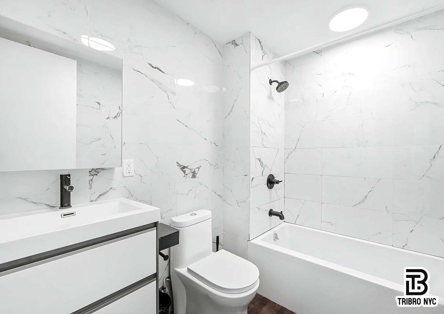 64 Stagg Street, Unit 3R Brooklyn, NY 11206 - Photo 7 of 7 a bathroom with a sink a toilet and a bathtub