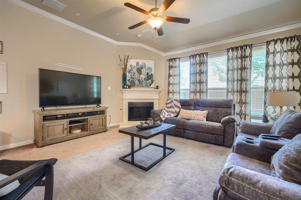 12417 Hitch Rack Way McKinney, TX 75071 - Photo 4 of 17 Carpeted living room with ceiling fan and crown molding