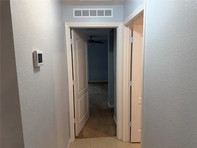 a view of a hallway with a door