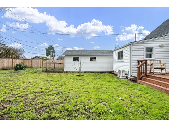 a view of a house with backyard and sitting area