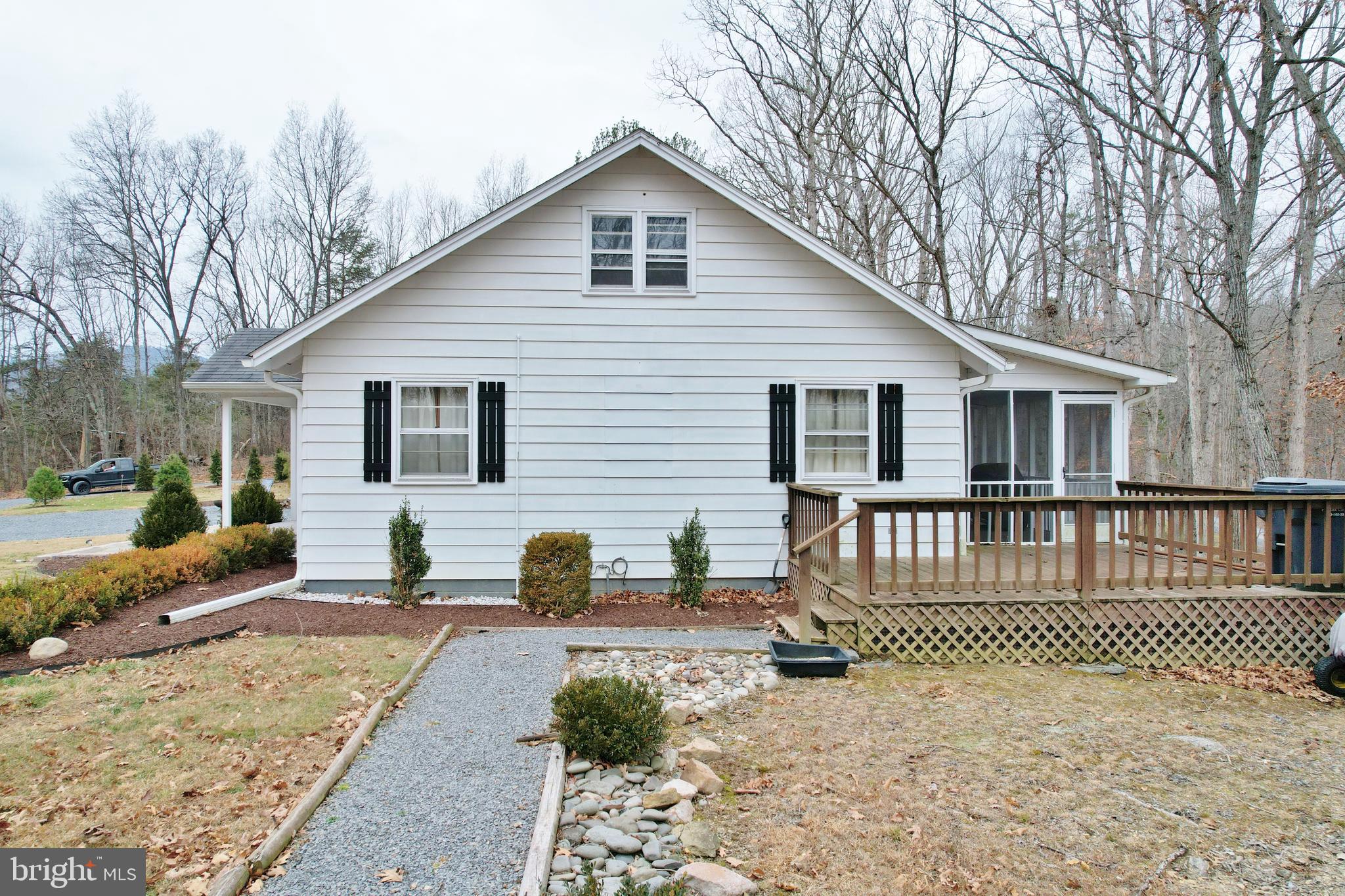 67 Plum Tree Lane Fort Valley, VA 22652 - Photo 11 of 47 a view of a house with a patio and a yard