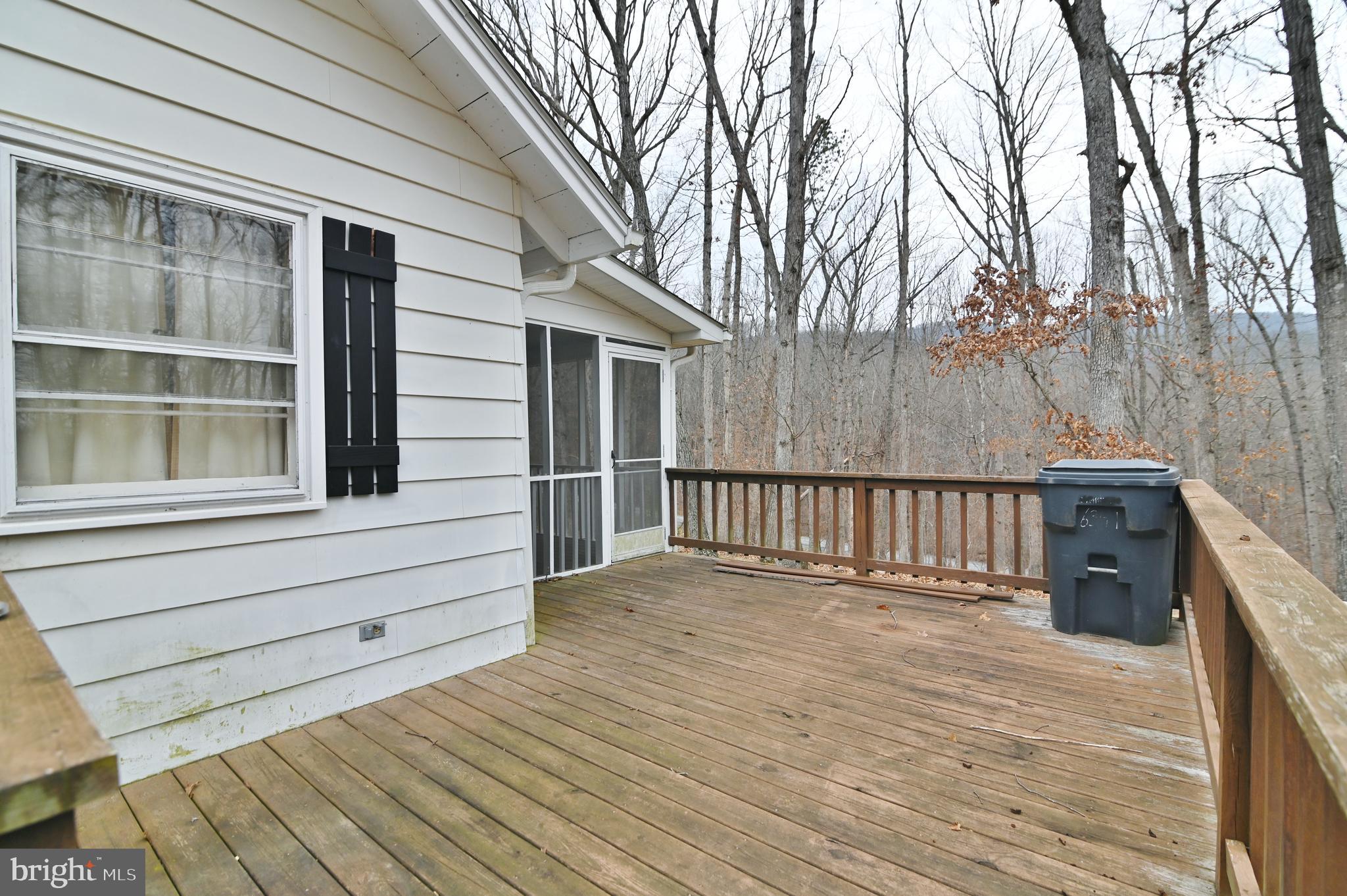 67 Plum Tree Lane Fort Valley, VA 22652 - Photo 12 of 47 a view of balcony with wooden floor and fence