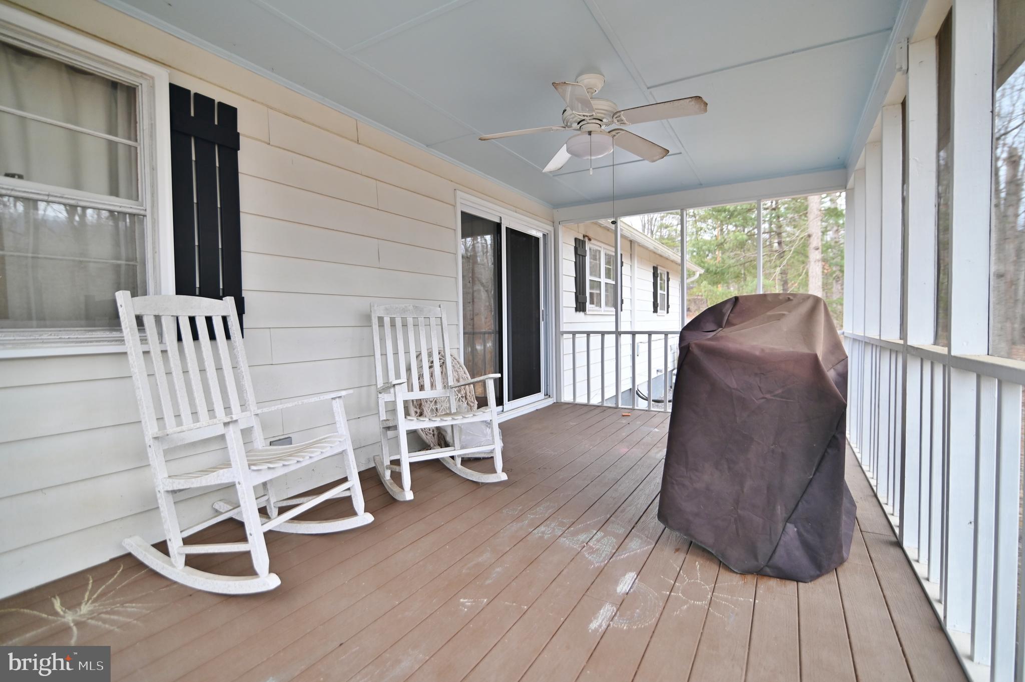 67 Plum Tree Lane Fort Valley, VA 22652 - Photo 14 of 47 a living room with wooden floor furniture and a large window