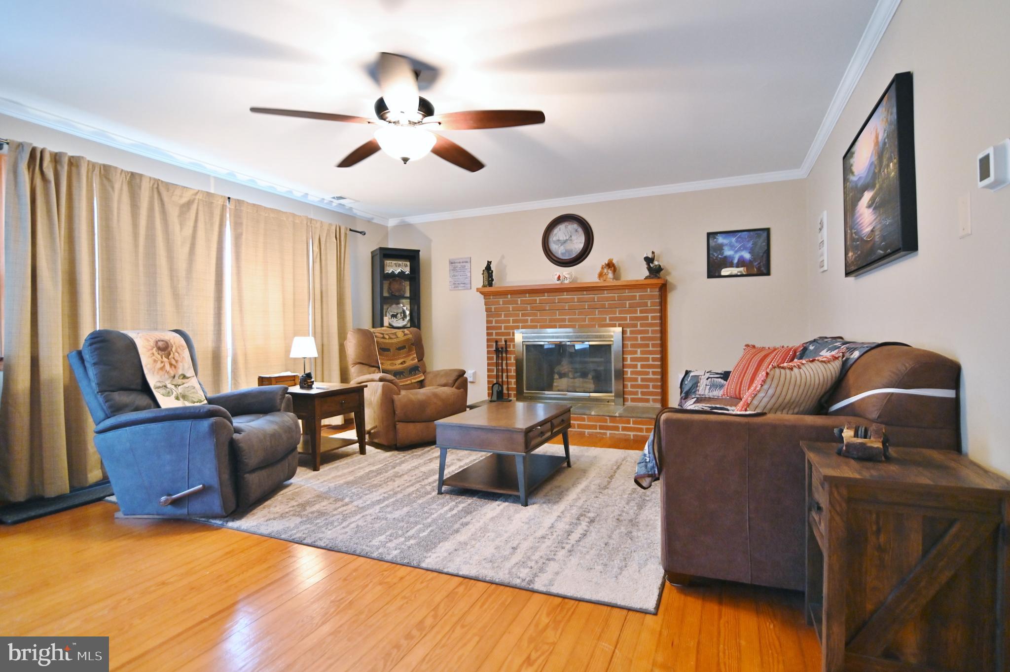 67 Plum Tree Lane Fort Valley, VA 22652 - Photo 18 of 47 a living room with furniture and a fireplace