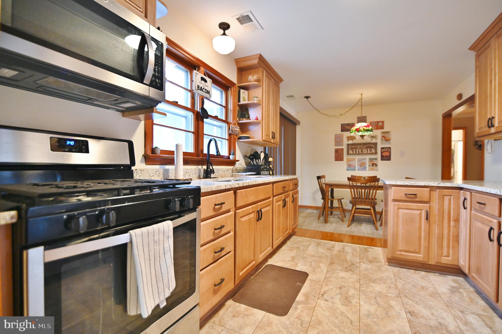 67 Plum Tree Lane Fort Valley, VA 22652 - Photo 22 of 47 a kitchen with stainless steel appliances granite countertop a stove a sink and a refrigerator
