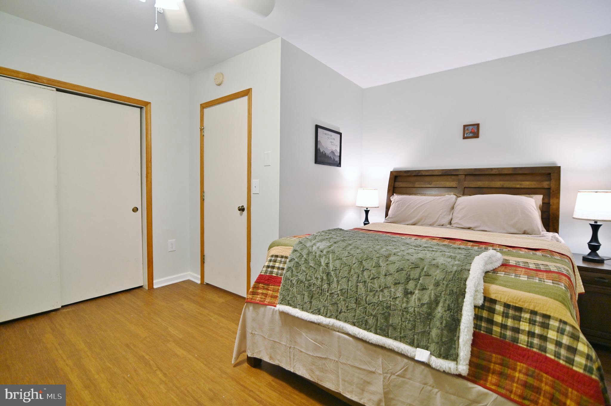 67 Plum Tree Lane Fort Valley, VA 22652 - Photo 28 of 47 a bedroom with a bed and wooden floor