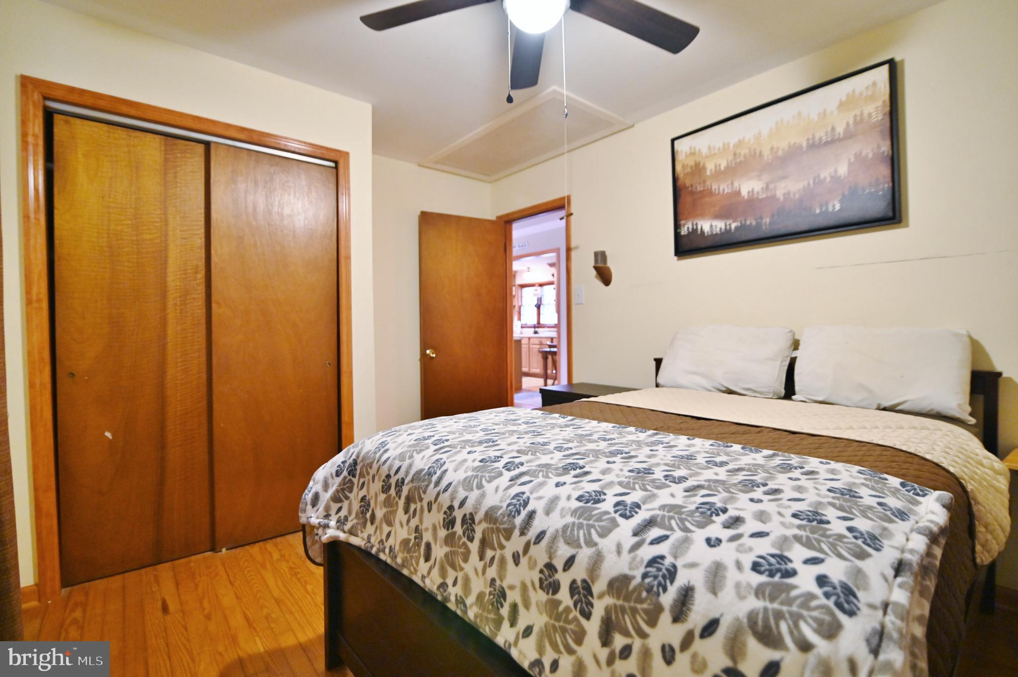 67 Plum Tree Lane Fort Valley, VA 22652 - Photo 34 of 47 a bedroom with a bed and a painting on the wall