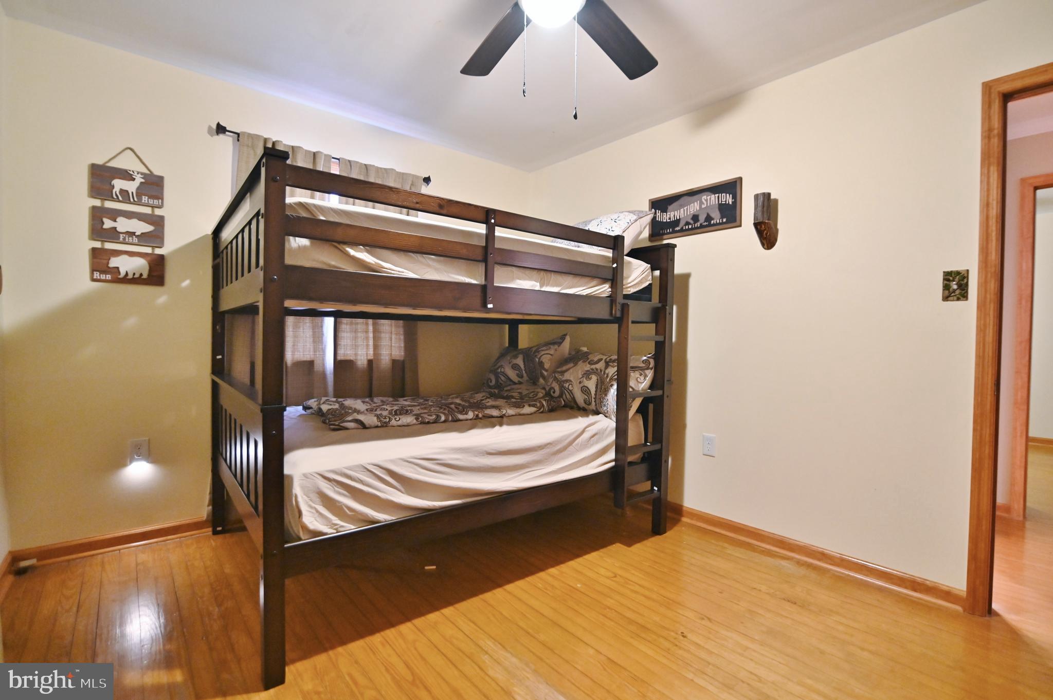 67 Plum Tree Lane Fort Valley, VA 22652 - Photo 35 of 47 a bedroom with a bed and lamp