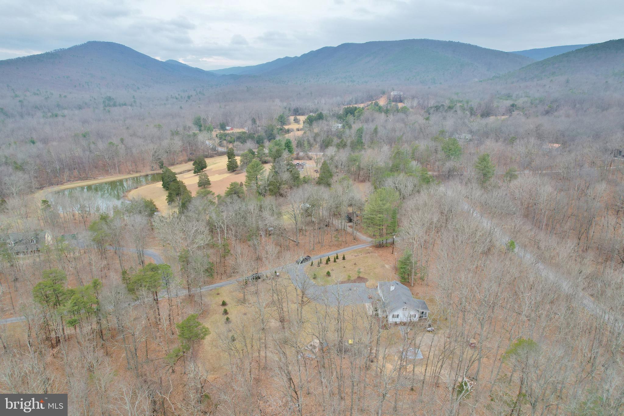 67 Plum Tree Lane Fort Valley, VA 22652 - Photo 8 of 47 a view of a dry yard with mountains in the background