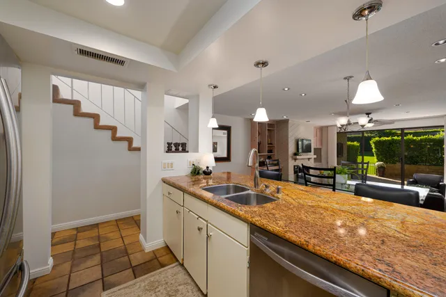 a kitchen with granite countertop a sink and a stove