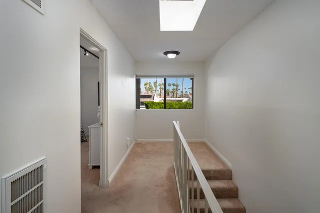 a view of a hallway with windows