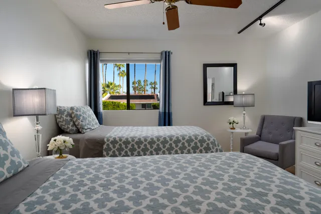 a bedroom with a large bed and a couch