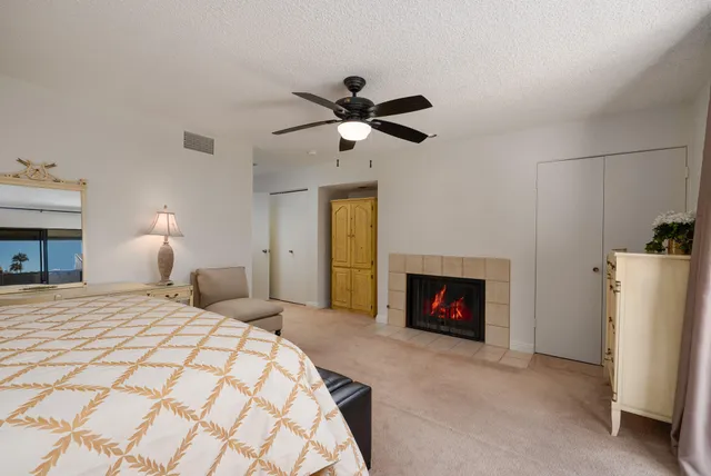 a bedroom with a bed and a fireplace