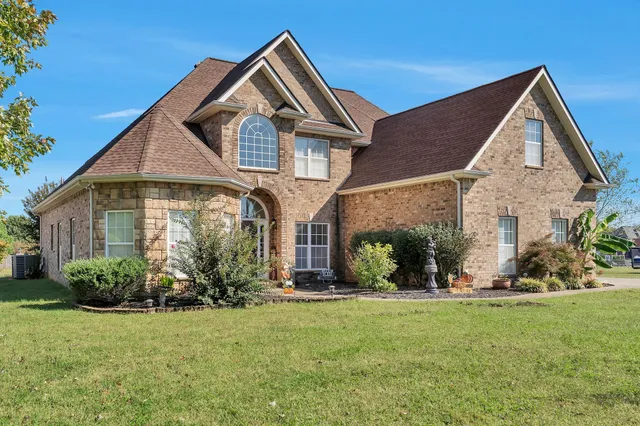 a front view of a house with a yard