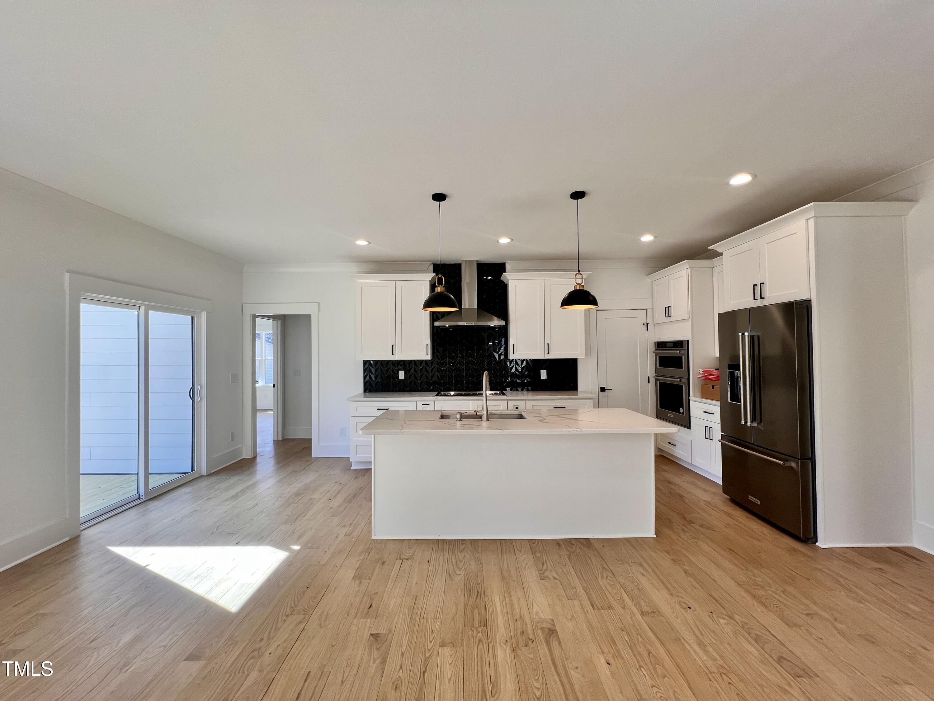 727 Cook Road Durham, NC 27713 - Photo 13 of 50 a kitchen with stainless steel appliances a refrigerator and a microwave