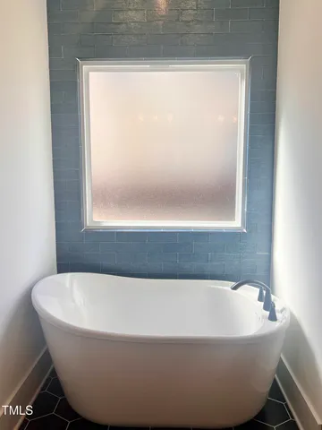 a white bath tub sitting next to a window