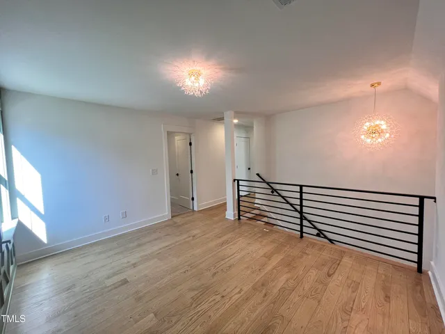 a view of a room with wooden floor