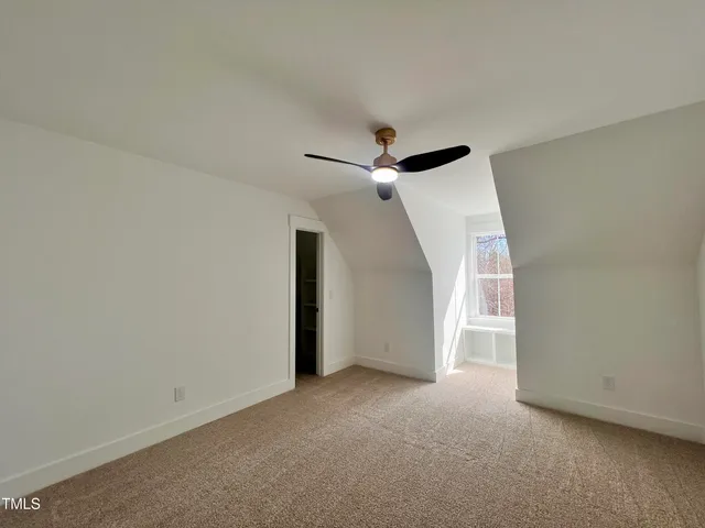a view of a livingroom with a ceiling fan and window
