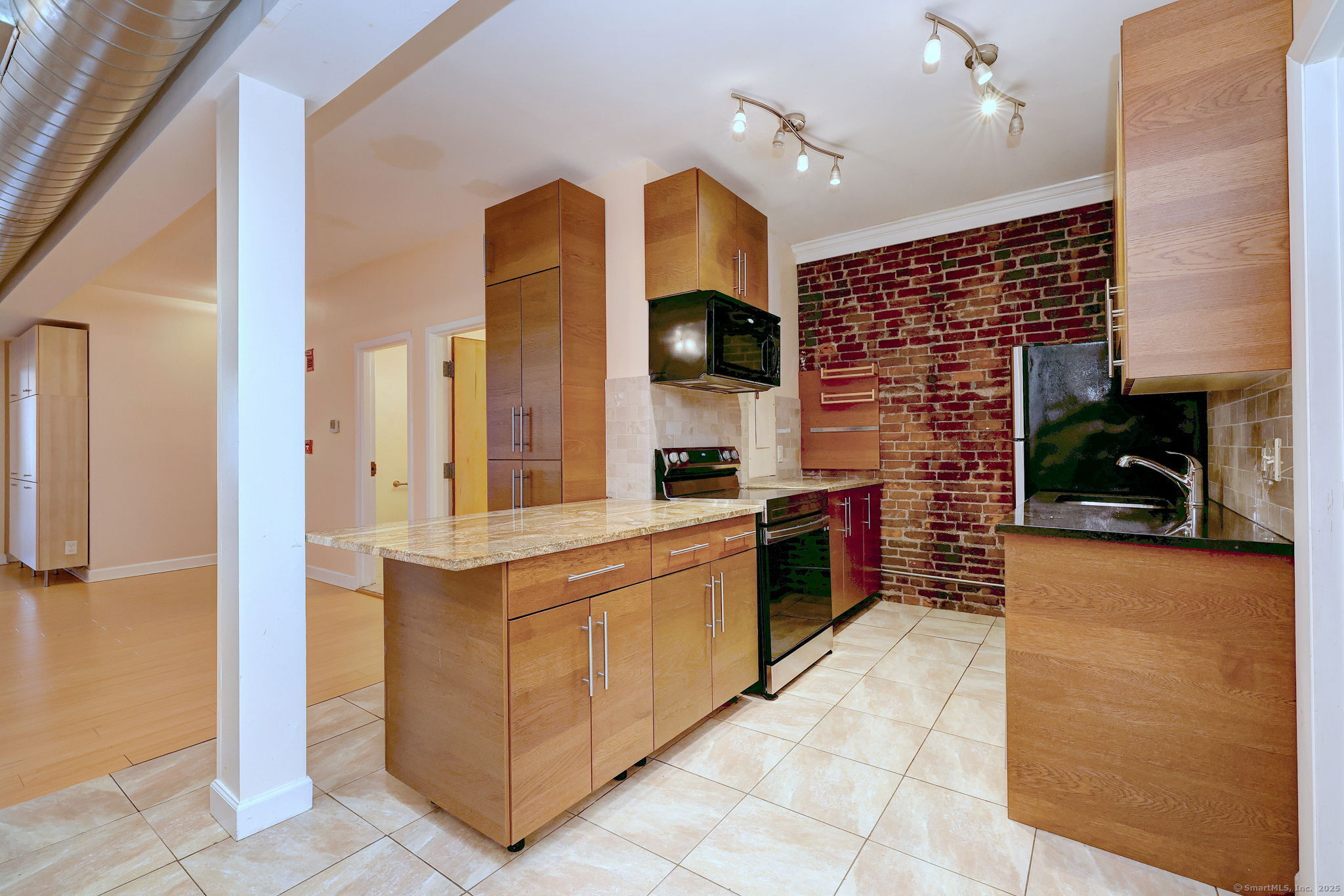 844 Grand Avenue, Unit 2 New Haven, CT 06511 - Photo 12 of 36 a large kitchen with stainless steel appliances granite countertop a stove and a refrigerator