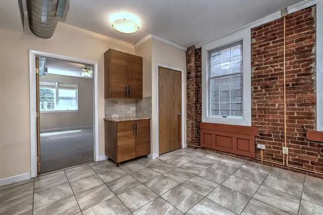 a kitchen with kitchen island a counter top space stainless steel appliances and cabinets