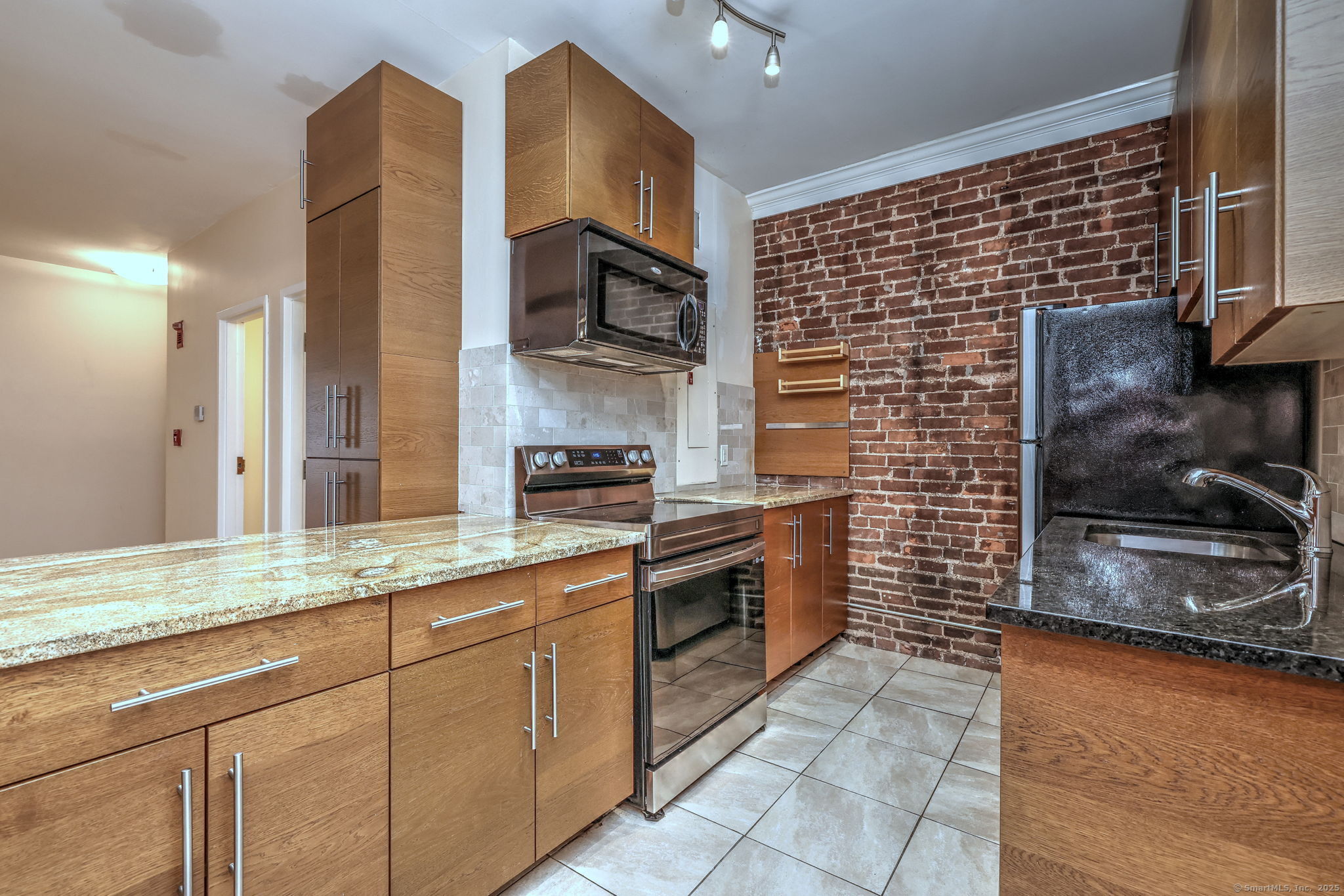 844 Grand Avenue, Unit 2 New Haven, CT 06511 - Photo 16 of 36 a kitchen with stainless steel appliances granite countertop a stove a sink and a microwave