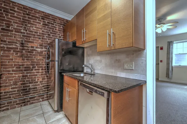 a large kitchen with stainless steel appliances granite countertop a large stove a sink and dishwasher