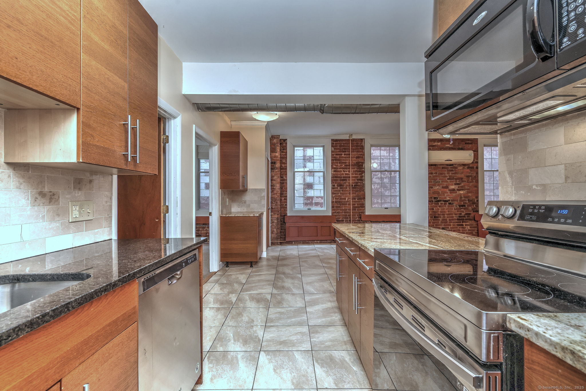 844 Grand Avenue, Unit 2 New Haven, CT 06511 - Photo 18 of 36 a large kitchen with stainless steel appliances granite countertop a large stove a sink and dishwasher